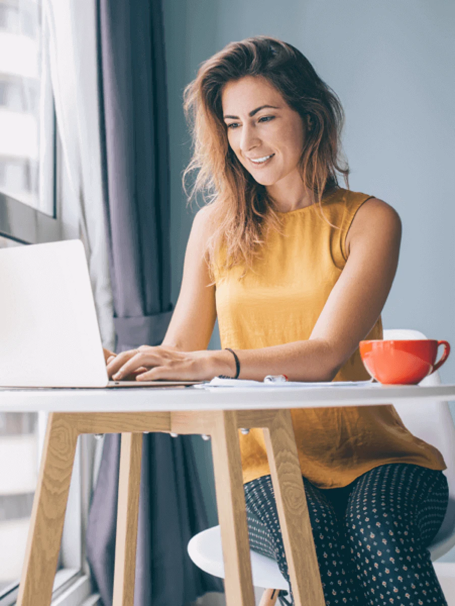 Person using a laptop while reviewing device maintenance tasks